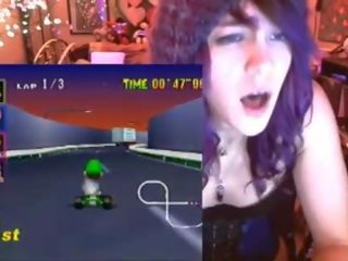 Geek young lady cums playing Mario Kart